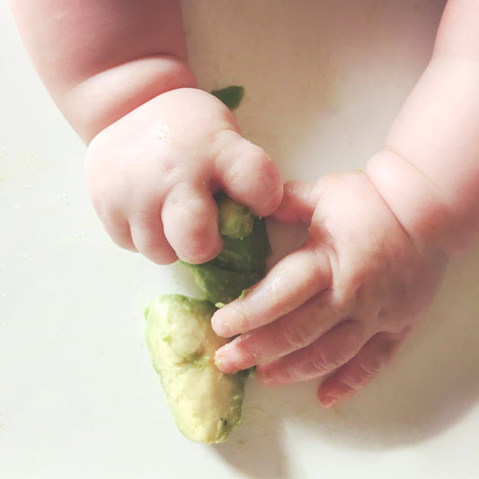 baby eating first solid foods
