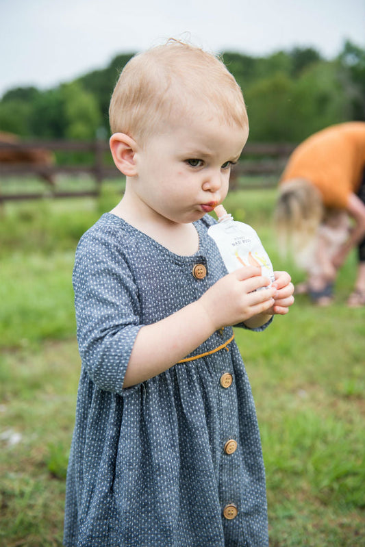child enjoying baby food pouch